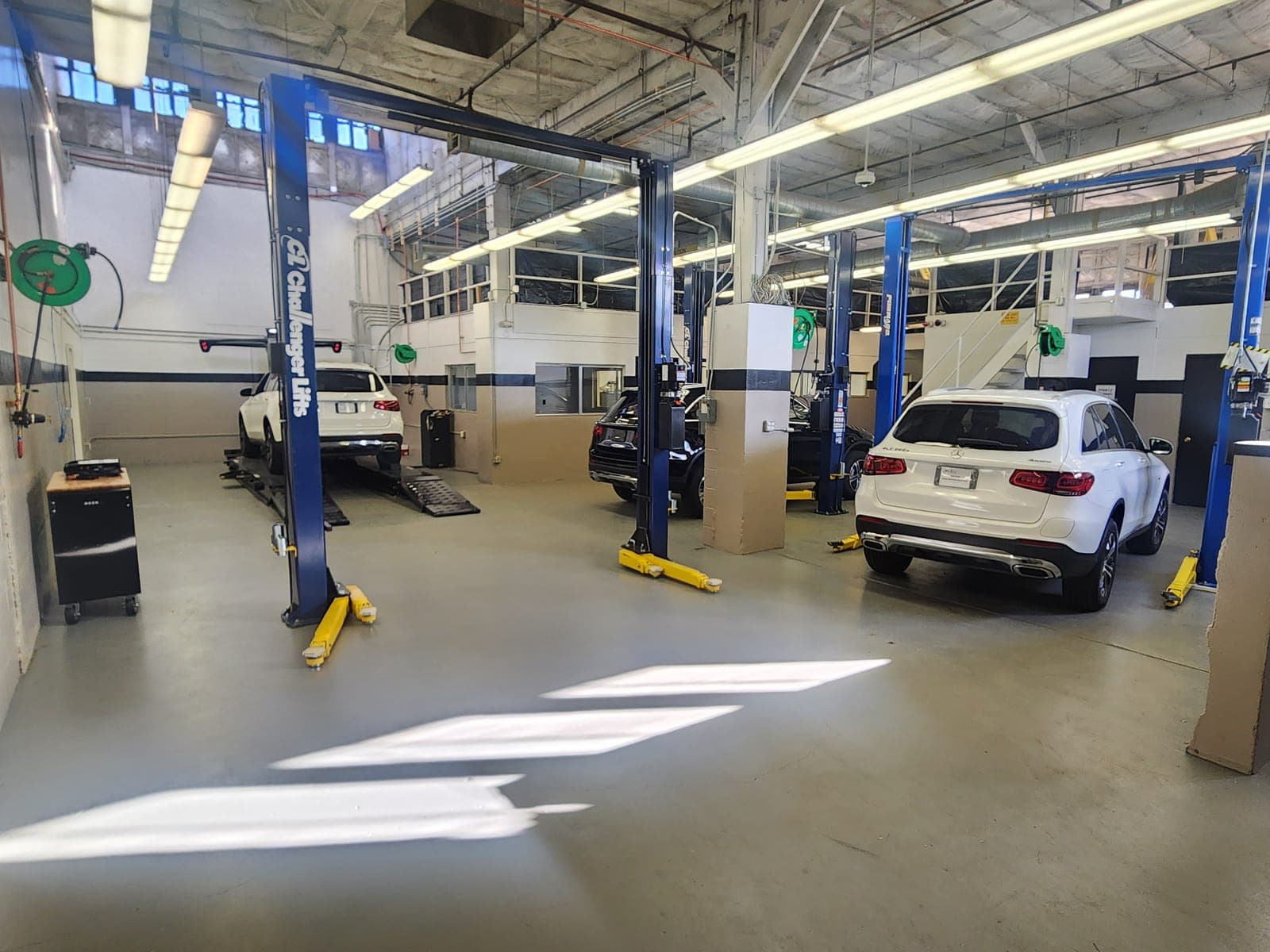 Spacious service bay with blue hydraulic lifts