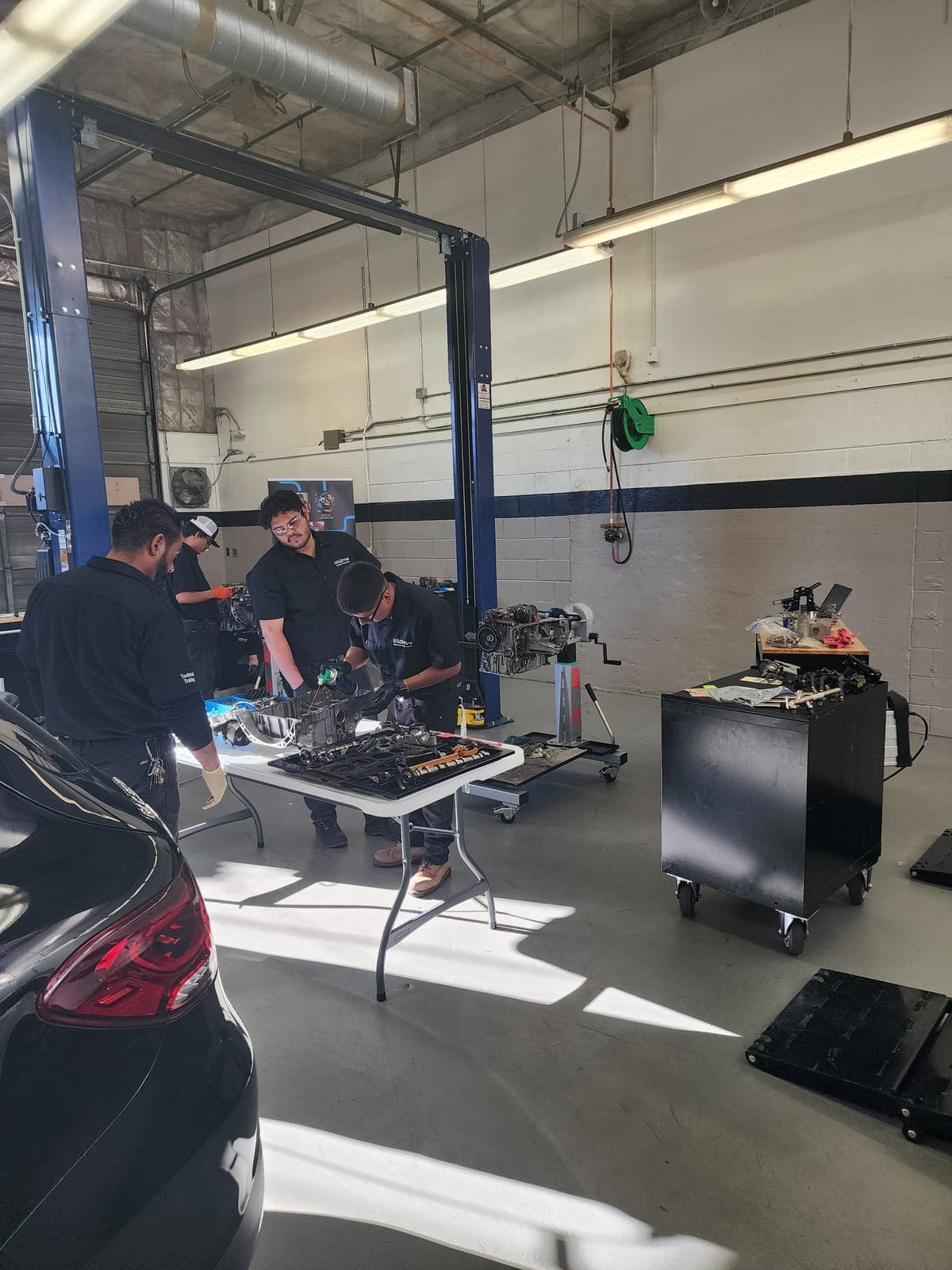 Student performing vehicle diagnostic and mechanical assessment