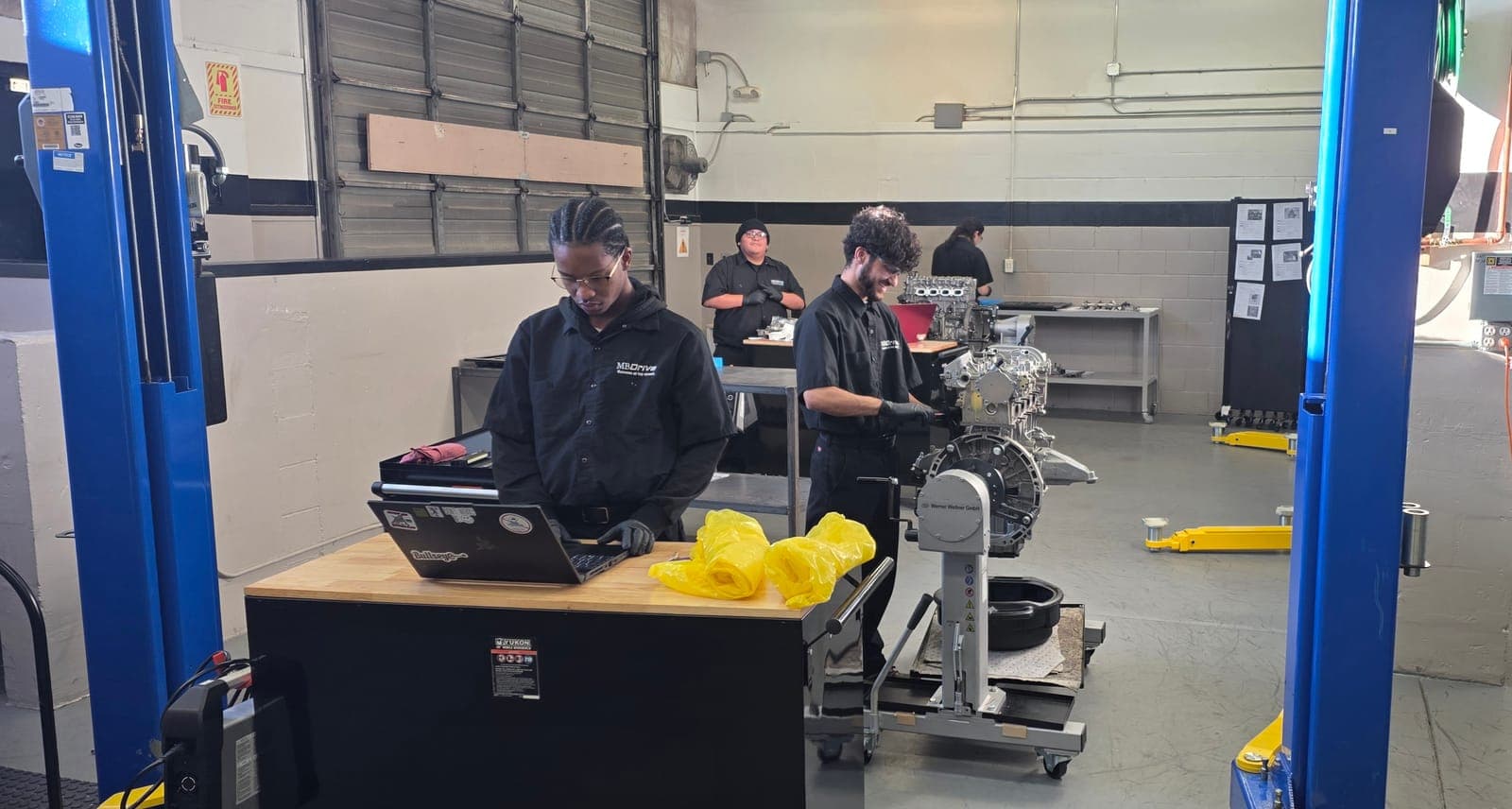 Student performing engine assembly and mechanical work