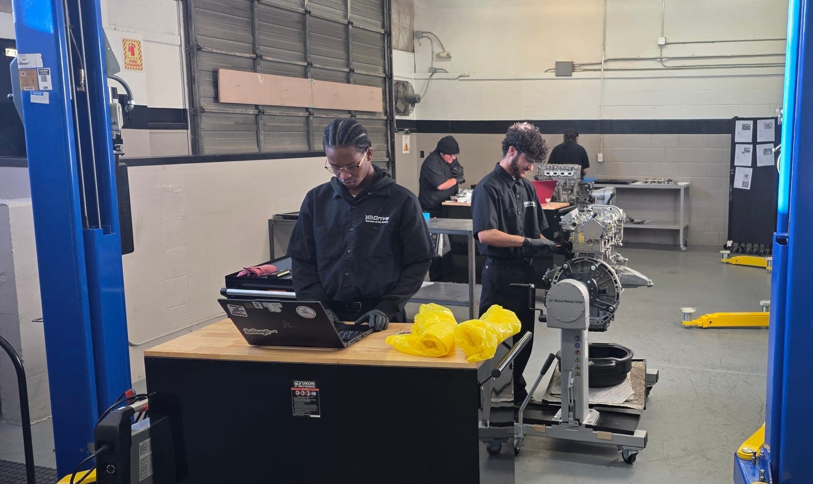 Close-up of student working on engine assembly